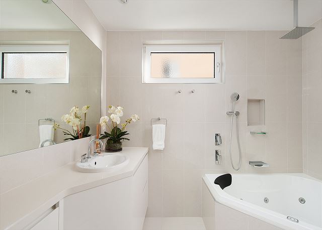 Bathroom with spa bath and shower