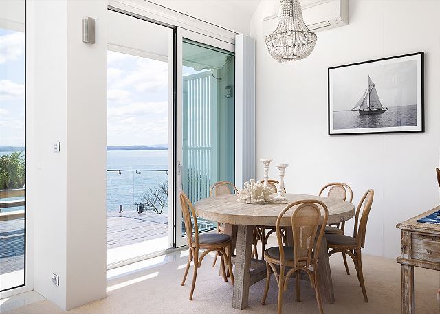 Dining table for six with a view over the bay