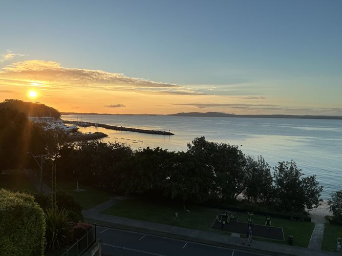 Sun setting over the Nelson Bay marina and breakwall